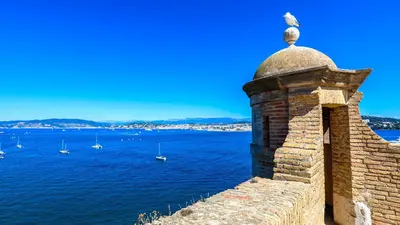 a brick wall with a view of the water and boats at Sea view, Luminous, Terrace, Garage, AC, Design in Cannes