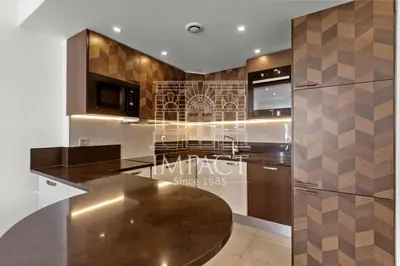 a kitchen with a wooden counter top and stainless steel appliances at REF 2019 - Apartment for rent Cannes Center in Cannes