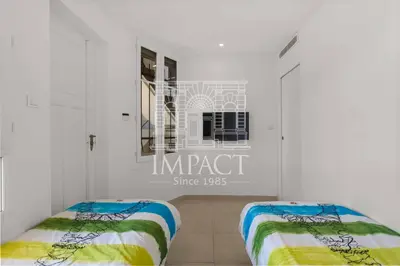 two beds in a room with white walls at REF 2019 - Apartment for rent Cannes Center in Cannes