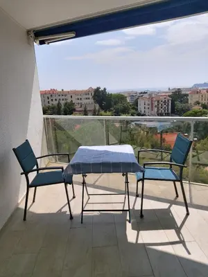 a table and two chairs on a balcony with a view at Studio Cannes beautiful sea view in Cannes