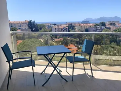 two chairs and a table on a balcony at Studio Cannes beautiful sea view in Cannes