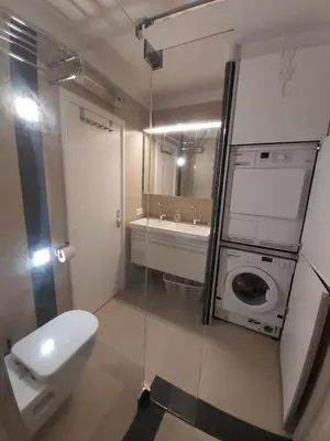 a bathroom with a toilet and a sink and a washing machine at Studio Cannes beautiful sea view in Cannes