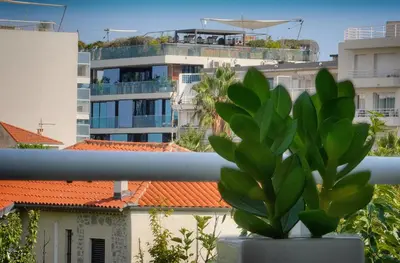 a plant in a pot on a balcony with buildings at Tine -Croisette-150M Plage- VCA in Cannes