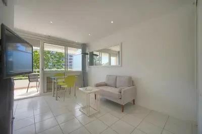 a living room with a couch and a table and a tv at Tine -Croisette-150M Plage- VCA in Cannes