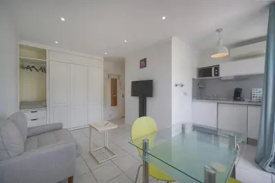 a living room with a glass table and a couch at Tine -Croisette-150M Plage- VCA in Cannes