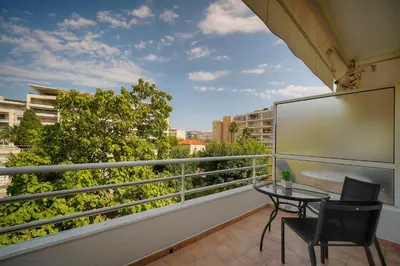 a balcony with a table and chairs on a balcony at Tine -Croisette-150M Plage- VCA in Cannes