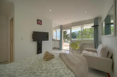 a bedroom with a bed and a couch and a television at Tine -Croisette-150M Plage- VCA in Cannes