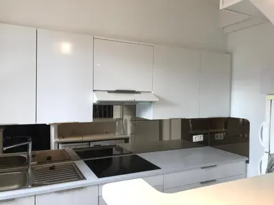 a kitchen with white cabinets and stainless steel appliances at Lovely 2 pièces Croisette Martinez in Cannes