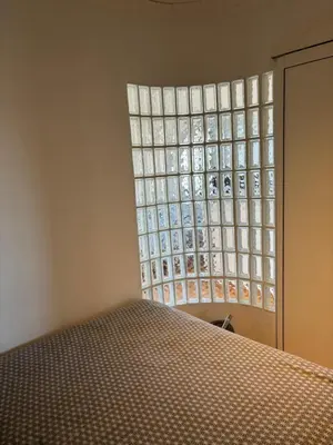 a bedroom with a large window in a room at Lovely 2 pièces Croisette Martinez in Cannes