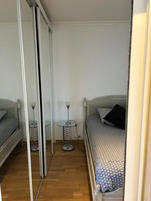 a small bedroom with a bed and a table at Lovely 2 pièces Croisette Martinez in Cannes