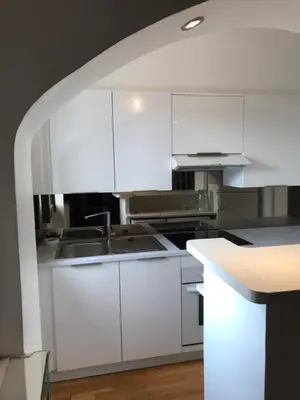 a kitchen with white cabinets and a sink at Lovely 2 pièces Croisette Martinez in Cannes