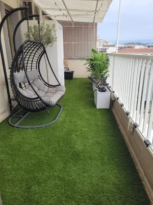 a swing on a balcony with green grass at Rooftop apartment Cannes center - Parking in Cannes