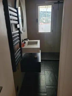 a bathroom with a sink and a window at Rooftop apartment Cannes center - Parking in Cannes