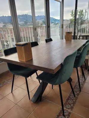 a wooden table and chairs in a room with windows at Rooftop apartment Cannes center - Parking in Cannes