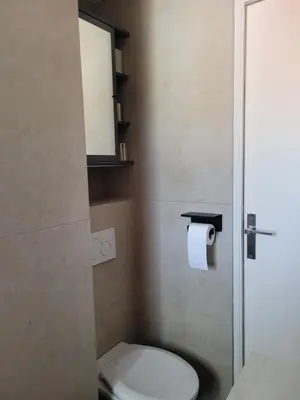 a bathroom with a toilet and a toilet paper dispenser at Rooftop apartment Cannes center - Parking in Cannes