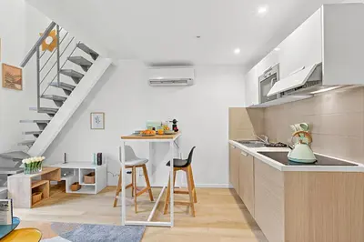 a kitchen with a sink and a counter with a staircase at Cosy Duplex Mimosa Cannes Center - Happy Rentals in Cannes