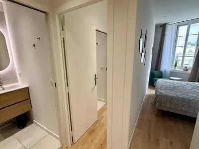a bathroom with a door leading to a bedroom at Lumière by Connexion in Cannes