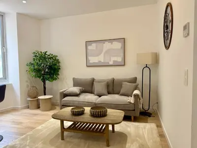 a living room with a couch and a table at Lumière by Connexion in Cannes