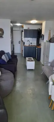 a living room with couches and a table in it at Cannes plages du Midi Appartements climatisés Bord de mer de 1 à 6 pers, 2 piscines, Parking privatif inclus in Cannes