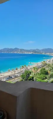a view of a beach and the ocean from a balcony at Cannes plages du Midi Appartements climatisés Bord de mer de 1 à 6 pers, 2 piscines, Parking privatif inclus in Cannes