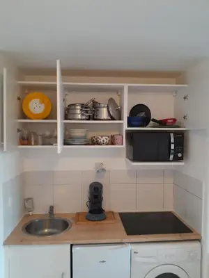 a kitchen with a sink and a microwave at Cannes plages du Midi Appartements climatisés Bord de mer de 1 à 6 pers, 2 piscines, Parking privatif inclus in Cannes