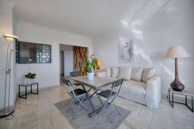 a living room with a table and a couch at Immogroom - 1 Bedroom - Sea view- AC in Cannes