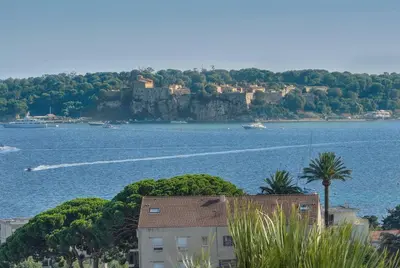 a view of a large body of water with a castle at Immogroom - 1 Bedroom - Sea view- AC in Cannes