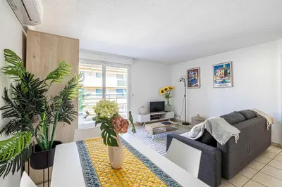 a living room with a couch and a table at Bright One bedroom Apt with Parking and Terrace in Cannes