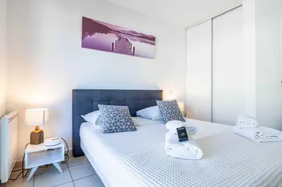 a bedroom with two beds in a room at Bright One bedroom Apt with Parking and Terrace in Cannes