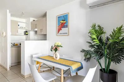 a dining room and kitchen with a table and chairs at Bright One bedroom Apt with Parking and Terrace in Cannes