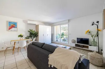 a living room with a couch and a table at Bright One bedroom Apt with Parking and Terrace in Cannes