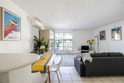 a living room with a couch and a table at Bright One bedroom Apt with Parking and Terrace in Cannes