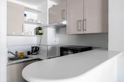 a kitchen with white cabinets and a counter top at Bright One bedroom Apt with Parking and Terrace in Cannes