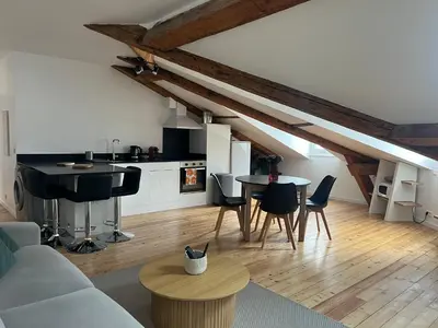 a living room with a couch and a kitchen at 3P Cannes 7 min Palais et Croisette in Cannes