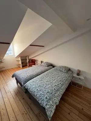 a kitchen with white cabinets and a black counter top at 3P Cannes 7 min Palais et Croisette in Cannes