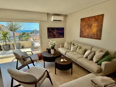 a living room with a couch and chairs and a balcony at Horizon by Connexion in Cannes