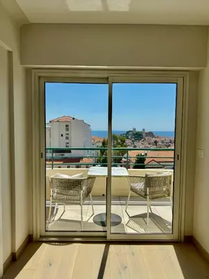 a living room with a table and chairs and a couch at Horizon by Connexion in Cannes