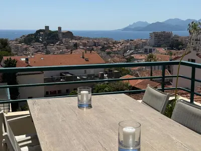 a balcony with white chairs and a view of the ocean at Horizon by Connexion in Cannes