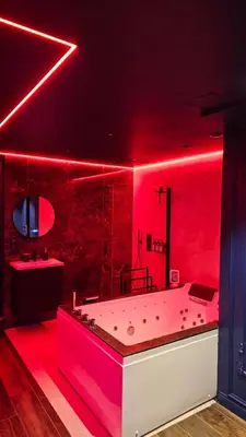 a red bathroom with a large tub in a room at Love room - Xtase By luxuria Cannes in Cannes