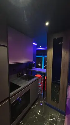 a kitchen with purple lighting and a stove top oven at Love room - Xtase By luxuria Cannes in Cannes