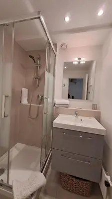 a bathroom with a shower and a sink and a mirror at Beau studio centre Cannes Maréchal Juin in Cannes