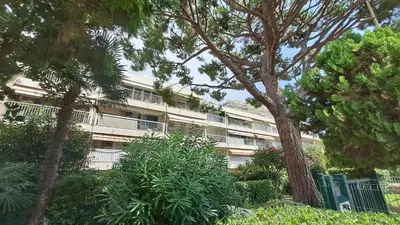 an apartment building with trees in front of it at Beau studio centre Cannes Maréchal Juin in Cannes