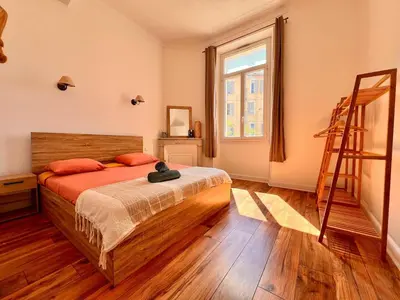 a bedroom with a bed and a ladder in it at Cannes centre - Forville Market in Cannes