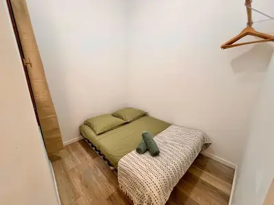 a small bed in a small room with a teddy bear on the corner at Cannes centre - Forville Market in Cannes