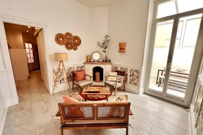 a living room with a fireplace and a couch at Cannes centre - Forville Market in Cannes