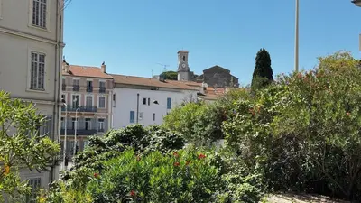 a group of buildings and trees in a city at Cannes centre - Forville Market in Cannes