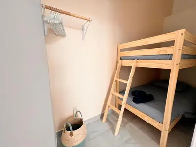 a bunk bed in a room with a ladder at Cannes centre - Forville Market in Cannes