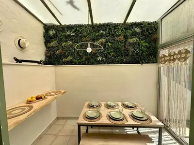 a room with a table and a green wall at Cannes centre - Forville Market in Cannes