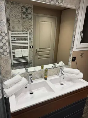 a bathroom with a sink and a large mirror at The Mazet in Cannes