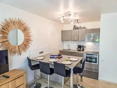 a kitchen with a table and chairs and a mirror at Apartment Villa Lerins-8 by Interhome in Cannes